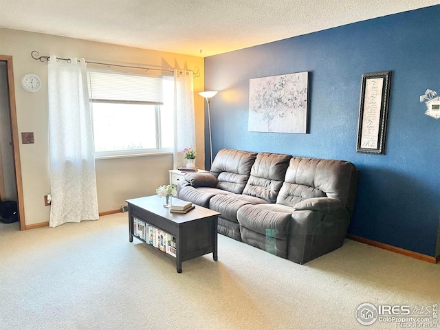 carpeted living room featuring a textured ceiling