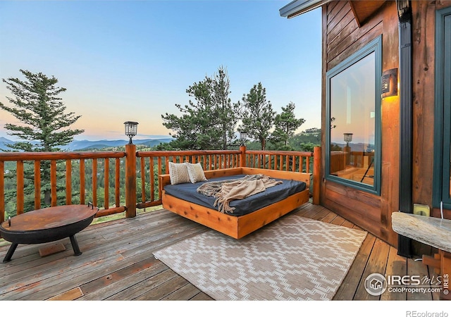 deck at dusk with a fire pit