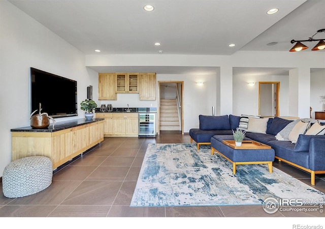 living room featuring beverage cooler and dark tile patterned floors