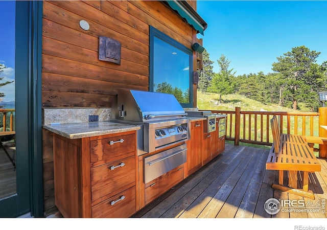 wooden deck featuring area for grilling