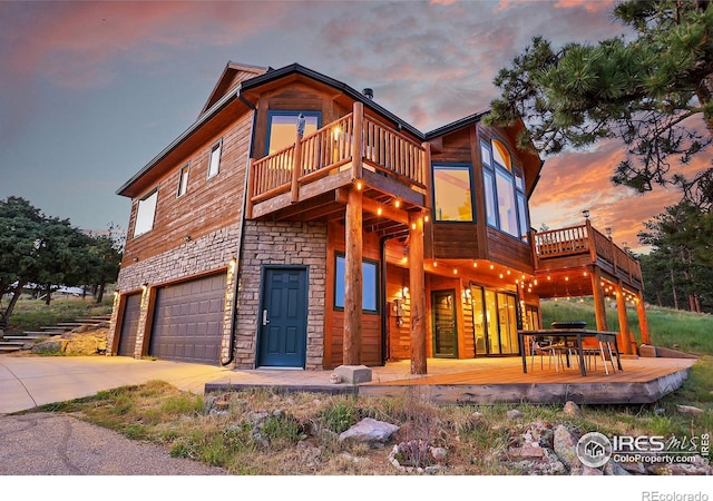 view of front of house with a garage and a balcony