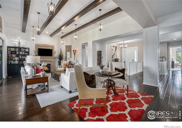 living room with beam ceiling, dark hardwood / wood-style floors, and a notable chandelier