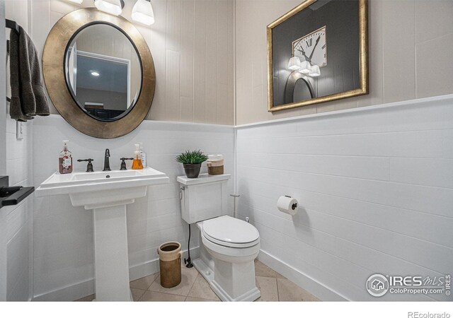 bathroom featuring tile patterned flooring and toilet