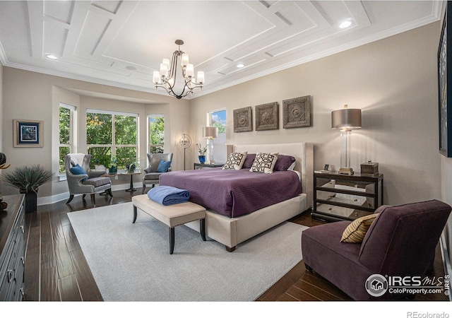 bedroom featuring dark hardwood / wood-style floors, ornamental molding, and an inviting chandelier