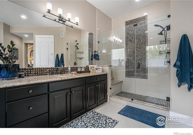 bathroom with vanity, tile patterned floors, and a shower with shower door