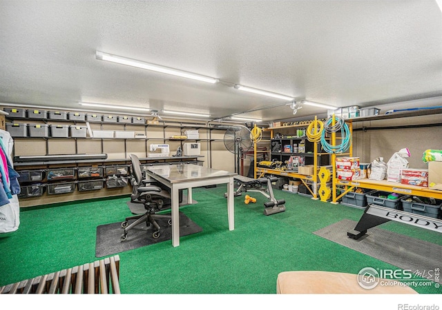 interior space featuring carpet flooring and a textured ceiling