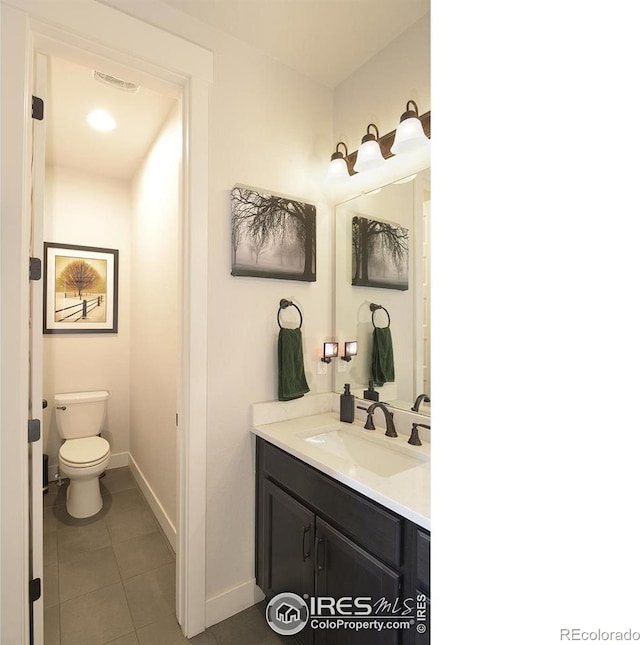 bathroom with tile patterned floors, vanity, and toilet