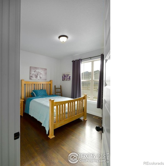 bedroom featuring dark hardwood / wood-style flooring