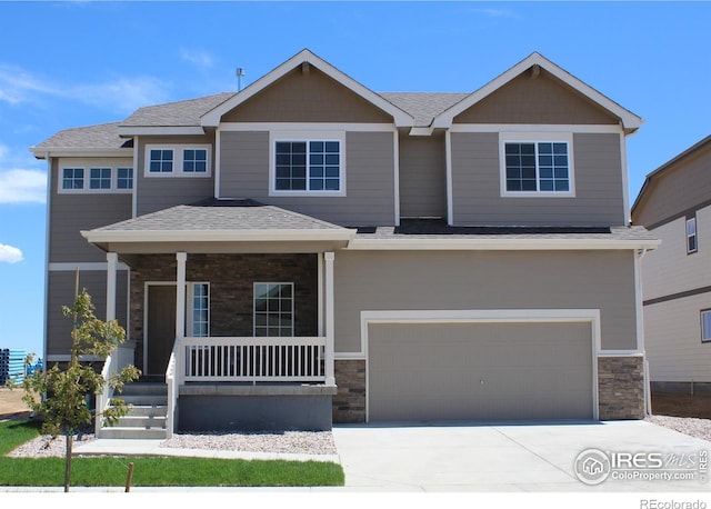 view of front facade featuring a porch and a garage