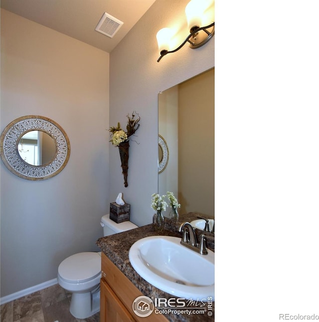 bathroom with vanity and toilet