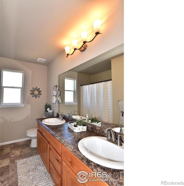 bathroom featuring vanity and toilet