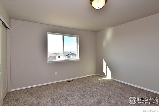 spare room featuring carpet flooring