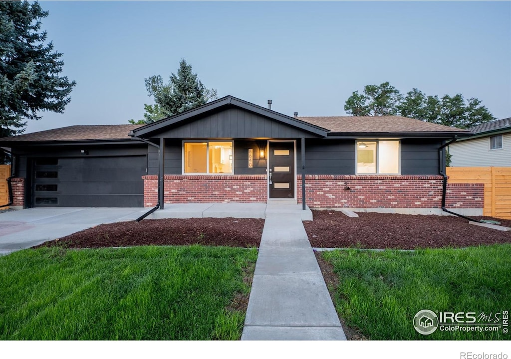 view of front of home with a garage and a front lawn