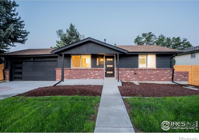 view of front of home with a garage and a front lawn