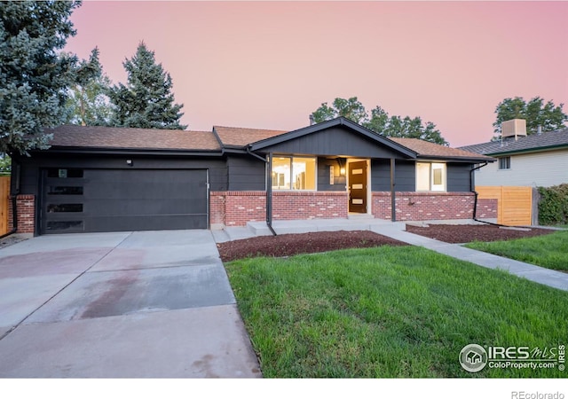 single story home with a yard and a garage