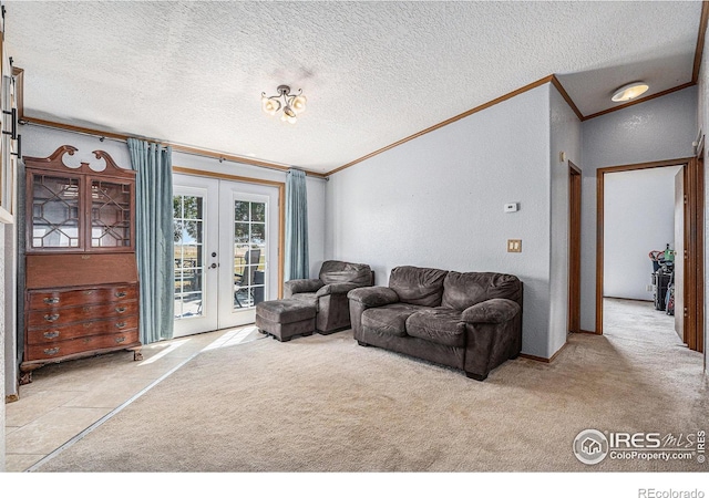 living room featuring french doors, light colored carpet, a textured ceiling, and ornamental molding