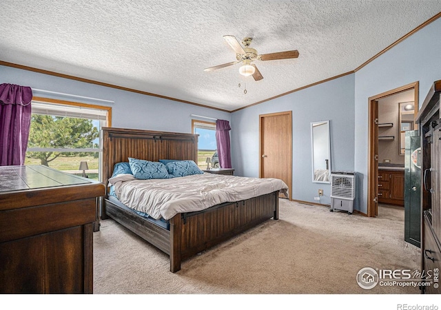 bedroom featuring ceiling fan, ensuite bathroom, vaulted ceiling, multiple windows, and light carpet