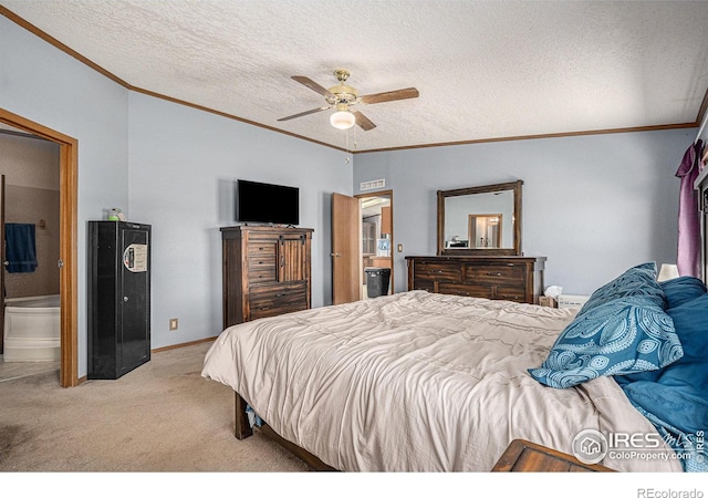 bedroom with crown molding, ensuite bath, ceiling fan, a textured ceiling, and light colored carpet