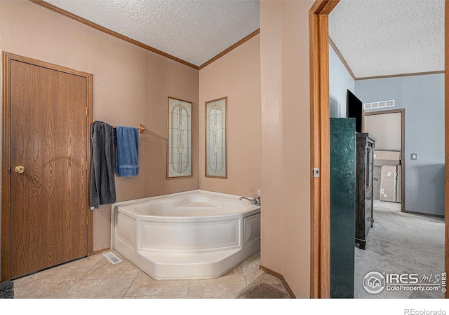 bathroom featuring a textured ceiling, crown molding, lofted ceiling, and a tub