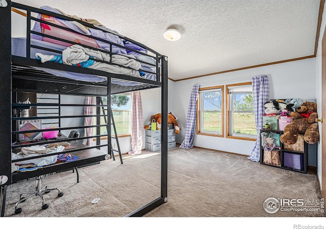 bedroom featuring a textured ceiling, carpet floors, and crown molding