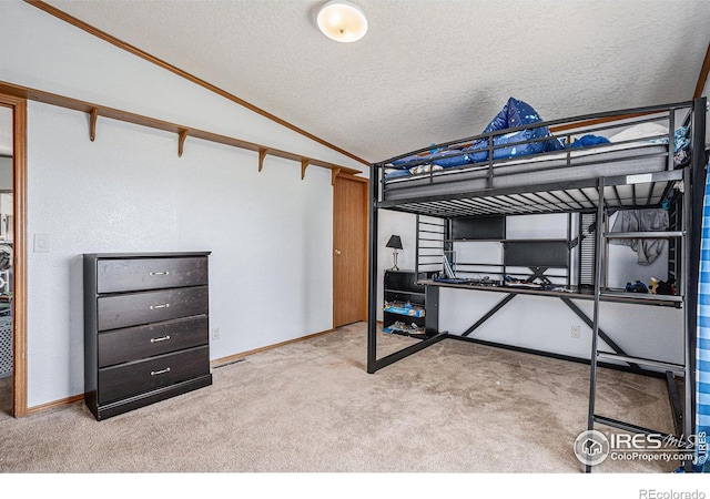 carpeted bedroom with a textured ceiling and lofted ceiling