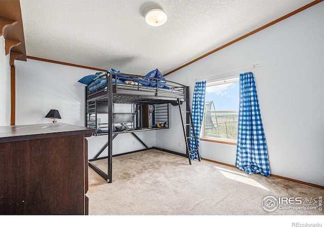 carpeted bedroom with a textured ceiling, crown molding, and lofted ceiling