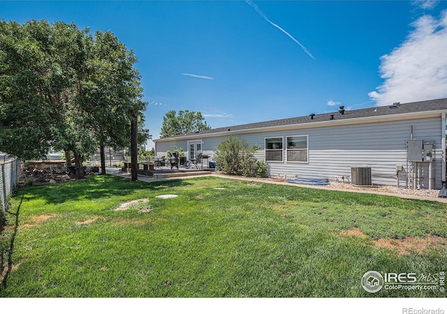 back of house with a patio area, a yard, and cooling unit