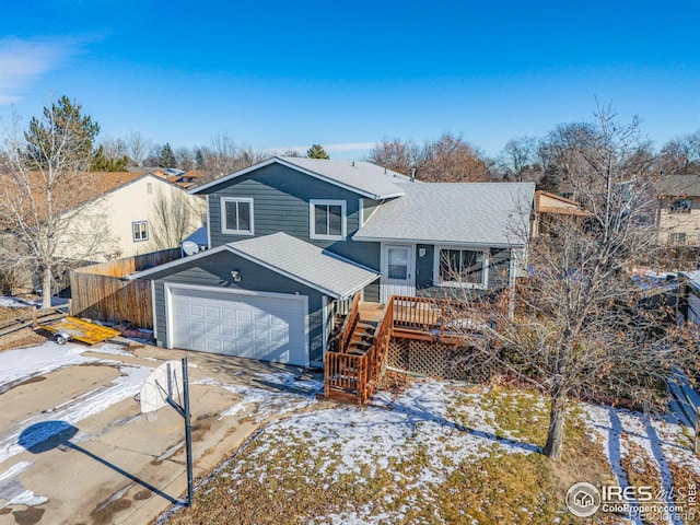 view of front of property featuring a deck and a garage