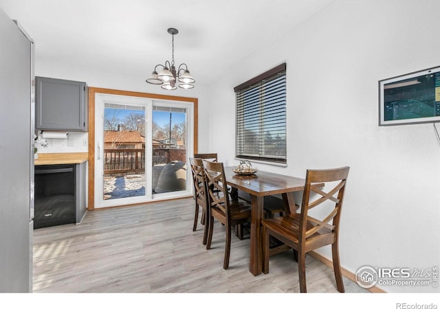 dining room featuring light hardwood / wood-style floors and an inviting chandelier