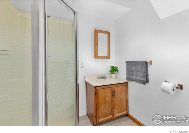 bathroom with vanity and a shower with shower door