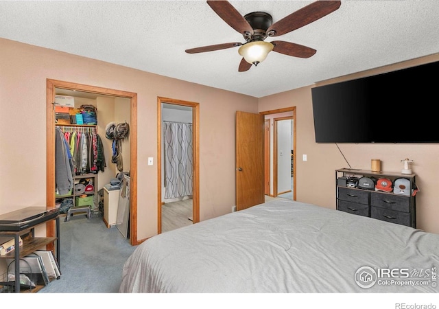 bedroom featuring light carpet, a textured ceiling, a closet, and ceiling fan