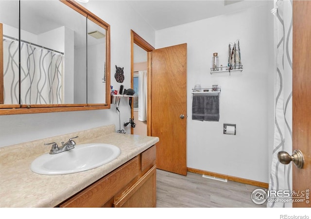 bathroom featuring hardwood / wood-style floors and vanity