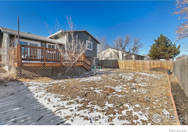 snow covered property with a wooden deck