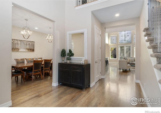 foyer featuring a notable chandelier and hardwood / wood-style floors