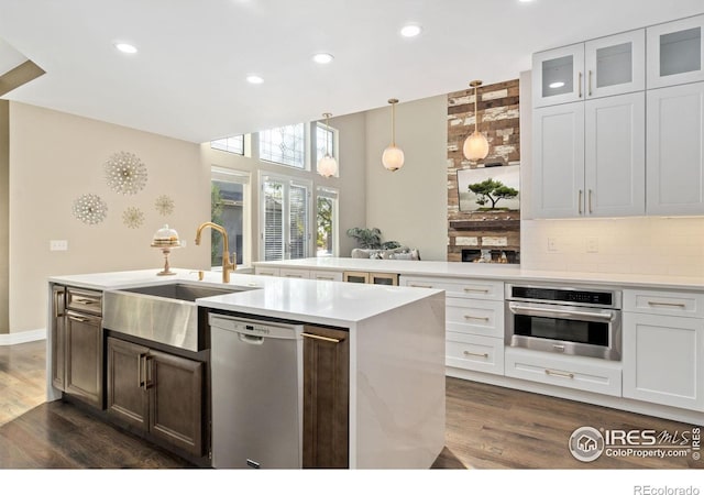 kitchen featuring sink, stainless steel appliances, white cabinetry, and backsplash