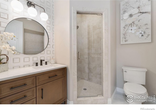 bathroom with a shower with door, vanity, and toilet