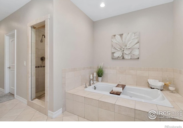 bathroom with shower with separate bathtub and tile patterned floors