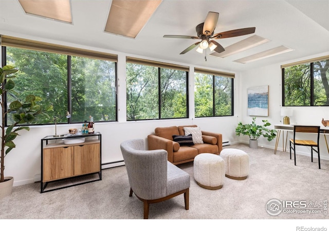 living room featuring baseboard heating, ceiling fan, and light carpet