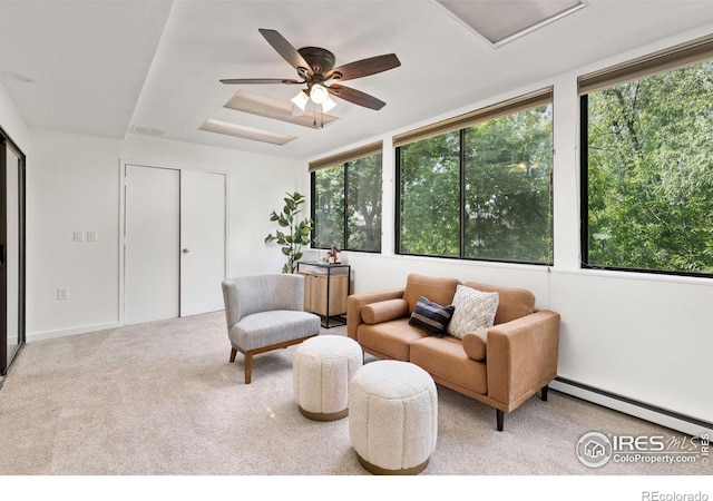 carpeted living room with ceiling fan, a baseboard radiator, and plenty of natural light