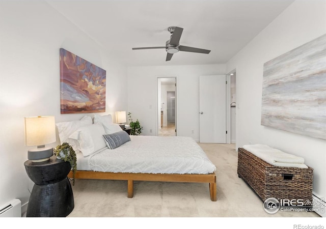 carpeted bedroom featuring a baseboard heating unit and ceiling fan