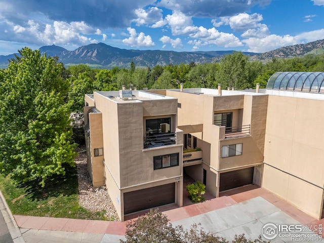 view of building exterior featuring a mountain view and a garage