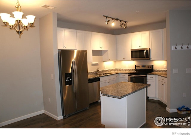 kitchen featuring pendant lighting, a center island, white cabinets, sink, and appliances with stainless steel finishes