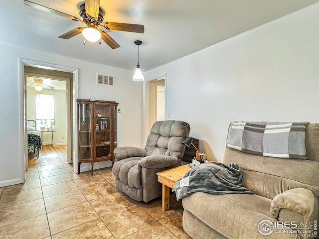 tiled living room featuring ceiling fan