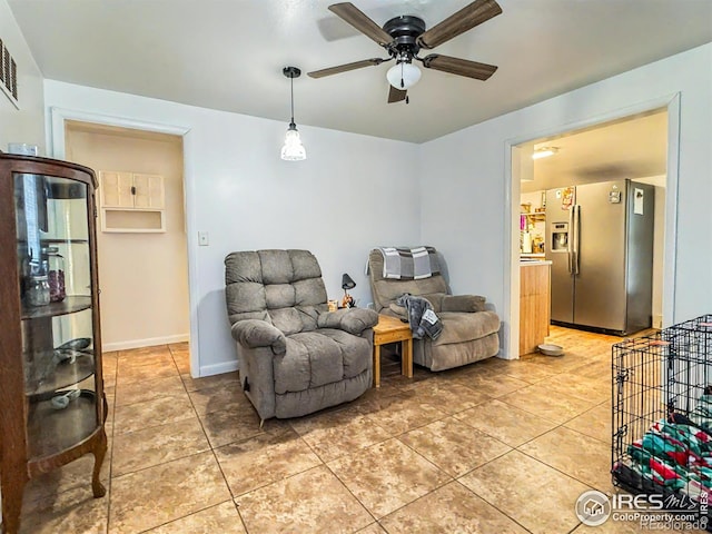 sitting room featuring tile patterned floors and ceiling fan