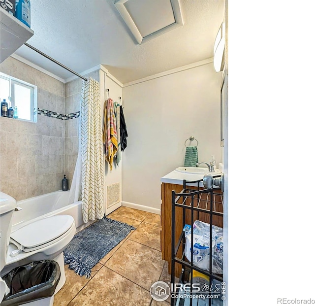 full bathroom with tile patterned floors, crown molding, toilet, shower / bath combo with shower curtain, and vanity