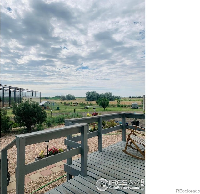 wooden deck with a rural view