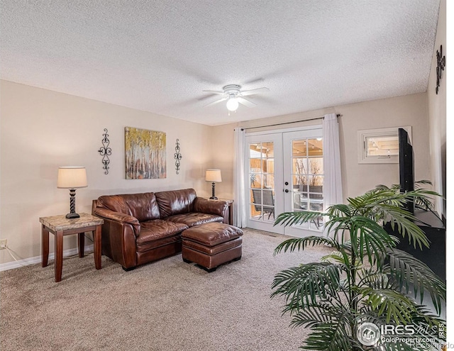 carpeted living room featuring ceiling fan, french doors, and a textured ceiling