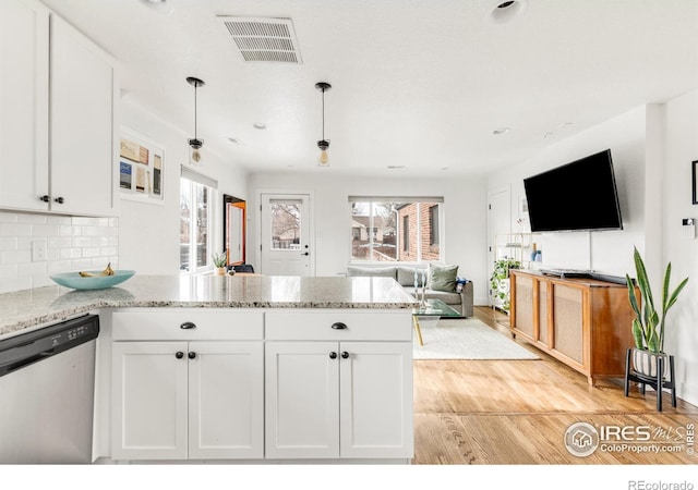 kitchen with dishwasher, pendant lighting, white cabinetry, and a wealth of natural light