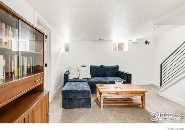 living room with light carpet and a textured ceiling