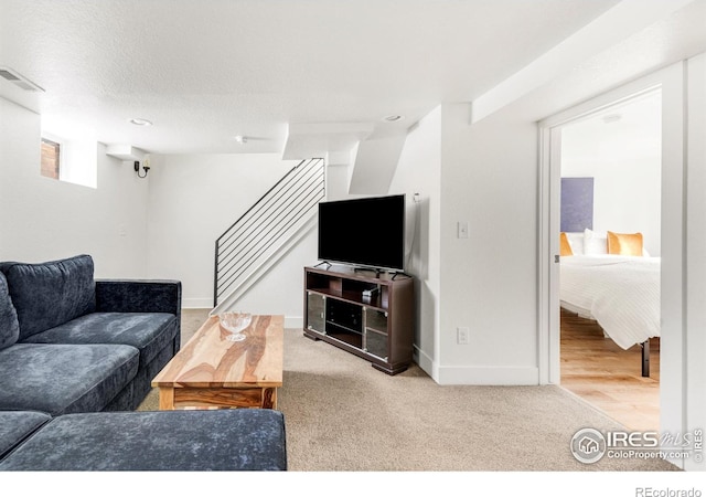 carpeted living room with a textured ceiling